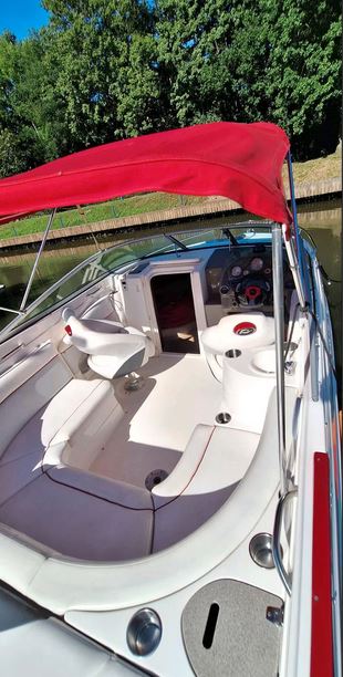 Rinker Captiva 246 mit rotem Bimini passend zu den roten Farbstreifen des Bootes, Blick ins Boot