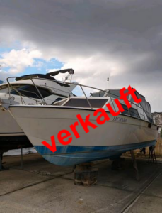 Boot Chris Craft mit einem quer über das Bild laufenden Schriftzug Verkauft in rot